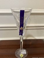 Front view of Waterford Snowflake Wishes Health flute showing ribbon and charm