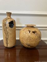Front view of both signed wood vases showing shapes and resin detail