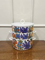 All three pieces stacked showing continuous Acapulco pattern and lid