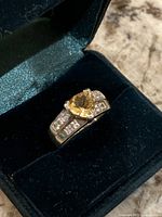 Ring in presentation box showing citrine center and CZ accents