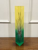 Full frontal view of vase showing gradient coloration and feather design