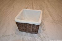 Oblique view of square woven basket showing exterior weave and liner