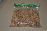Front view of sealed bag filled with mixed-color stone chips