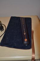 Straightener on pouch, copper accents visible