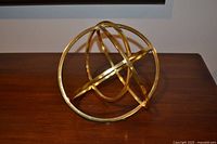 Gold-tone metal knot sculpture on tabletop