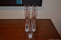 Front view of five flutes standing on table