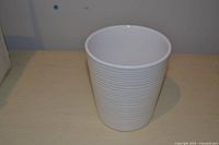 Front view of white ribbed ceramic vase