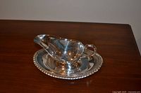 Gravy boat resting on matching underplate