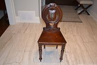 Front view of wooden side chair showing shield backrest and turned legs