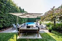 Table centered in patio setting, full length view under umbrella