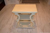 Side view of entire table showing scroll supports and two shelves