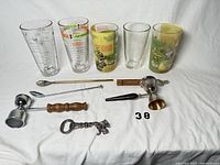 Overall lot: five glasses, bar spoons, jiggers, openers