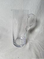 Tall clear glass pitcher with handle