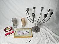 Group shot of all items including candelabra, two vases, framed print, coaster set