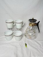 Full set: four mugs and carafe displayed