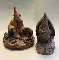 Both Tom Clark gnome sculptures side by side
