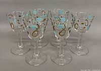 Front view of six patterned stemmed cocktail glasses