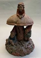 Full view of Tom Clark gnome sculpture showing all three figures and mushroom