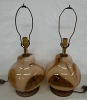 Front view of both matching art glass lamps showing overall form and height