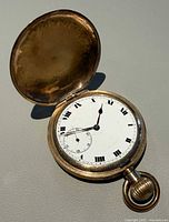 Pocket watch open showing dial, hands, and bow