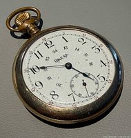 Front view of Omega pocket watch showing dial and case