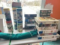 Cylindrical tube puzzles, boxed puzzles, green RolloPuzz mat on table