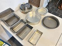 Group of assorted baking pans laid on table