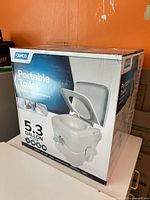 Front of Camco Portable Toilet retail box showing brand and 5.3 gallon capacity