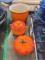 All three Le Creuset Flame stoneware pieces on countertop