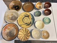 overhead view of all 14 ceramic pieces showing colors, shapes and condition