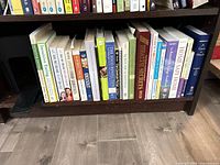 Full shelf view showing entire row of approximately 25 health, nutrition and self-help books