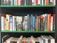 Two shelves of paperback books; bottom shelf labelled 'Shelf 2 – 27 Books' constitutes lot; shows full range of spines