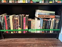 Full shelf view of all 29 paperback books