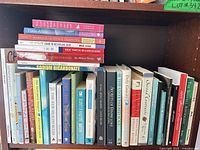 Full shelf showing approximately 30–35 mixed-format health, wellness and self-help books