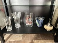 Group shot of five vases on shelf