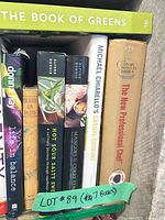 Spine view of seven hardcover cookbooks showing titles, authors, dust jackets and tape label indicating lot count