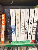 Spine view of all eight Ottolenghi hardcover cookbooks on shelf