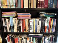 Three shelves showing assorted books; illustrates quantity and variety of formats