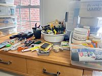 Overall lot on workbench showing tools, basin with implements, scissors, rulers and containers