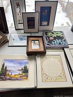 Group shot of all prints and ceramic plaque on table