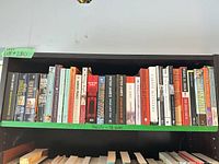 Full shelf showing all 28 paperback novels