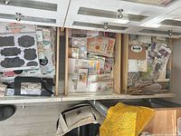 Drawer with sticker sheets, die-cuts, small embellishment packs