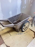 Side view of Rubbermaid cart showing tub, handle, wheels