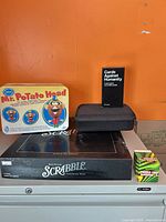 All five boxed/tinned/encased items grouped together