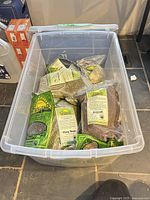 Open storage tote filled with mixed seed packages