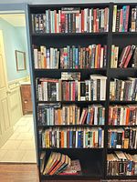 Front view showing full height bookcase filled with books