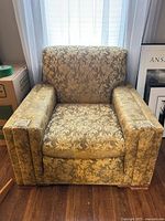 Front view of mid-century floral tapestry armchair