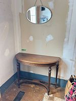 Console table and oval mirror together in corner