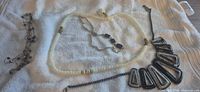 Four necklaces laid out on towel