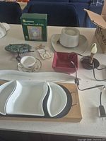 overview of lot showing serveware, hat, candle holder box, lamp